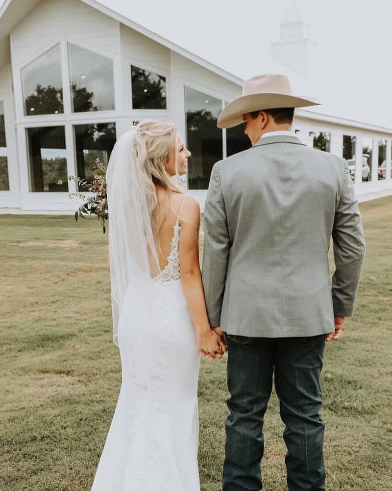 bride and groom looking over their shoulders at each other