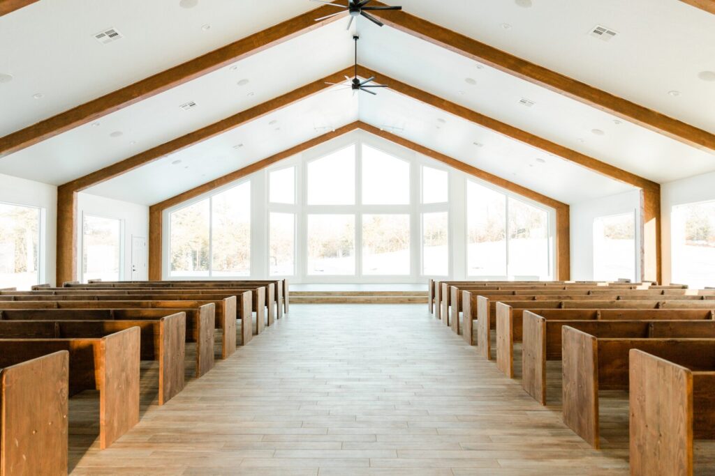 church pews facing large open windows in wedding chapel